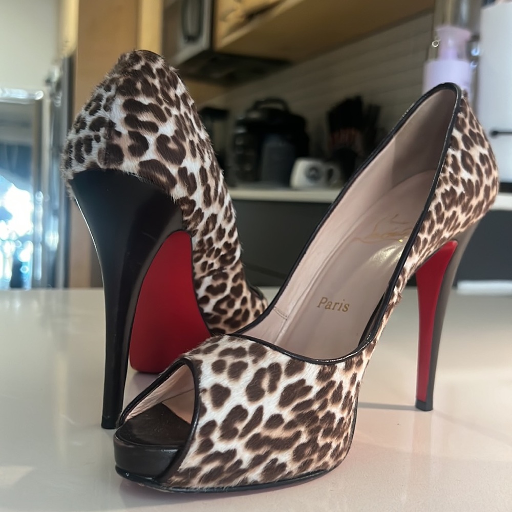 Christian Louboutin Red Bottom Heel. Crafted w/ Calf Hair and a Peep Toe